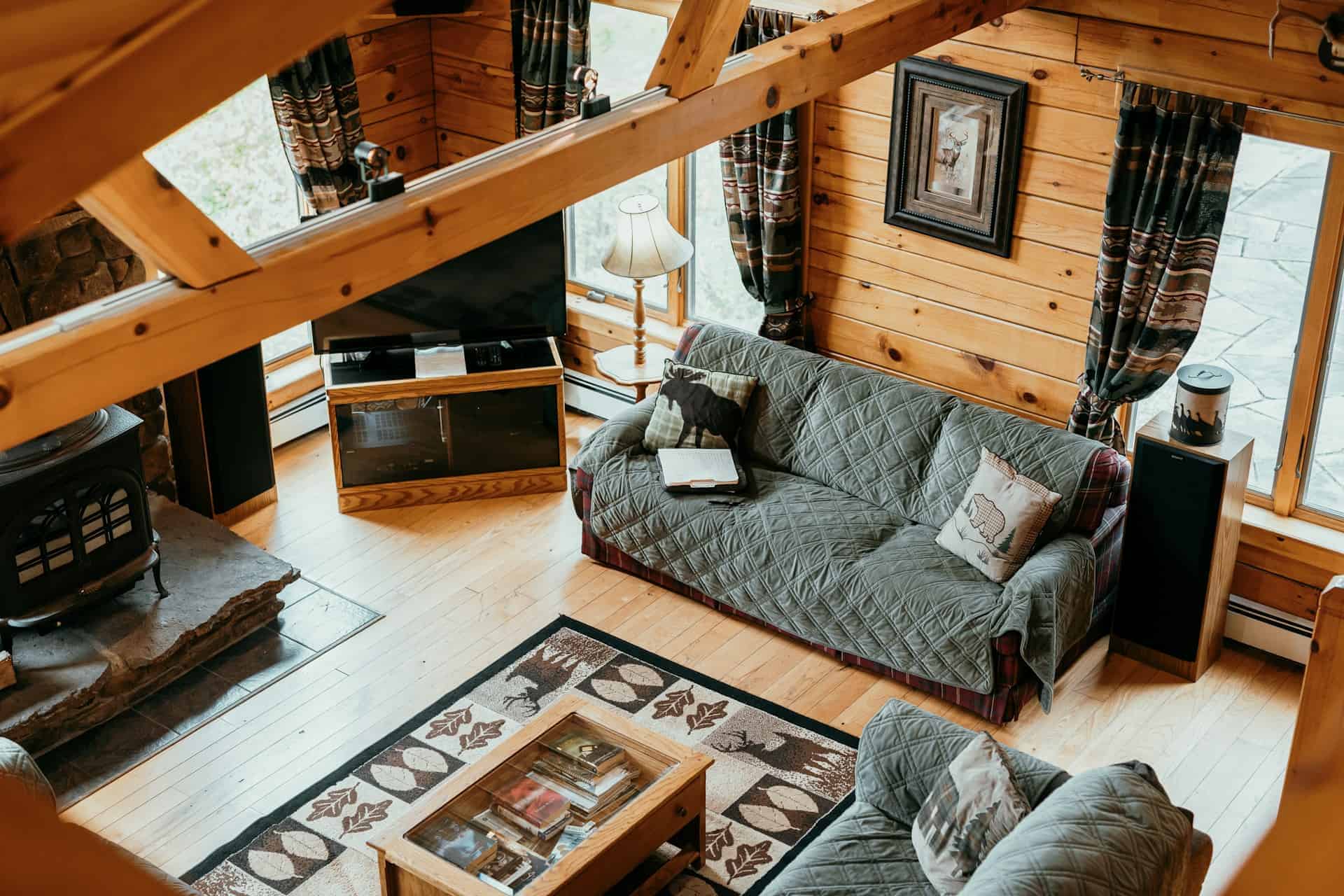 2. Stilul provensal - living, lemn, grinzi, canapele, șemineu, comodă, TV, ferestre, draperii, covor, măsuță de cafea